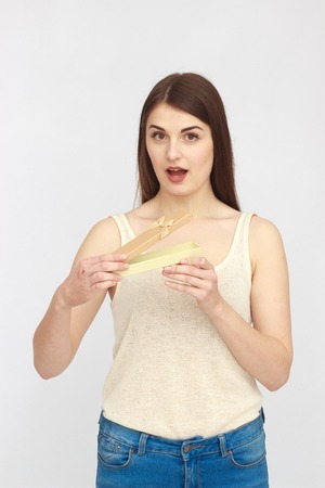 Young excited woman with gift on white backgroundの写真素材