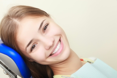 Portrait of female patient smiling in dentistryの写真素材