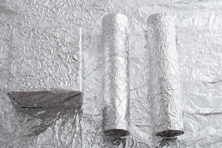 Silver foil figures with shiny crumpled surface. Contemporary artの写真素材
