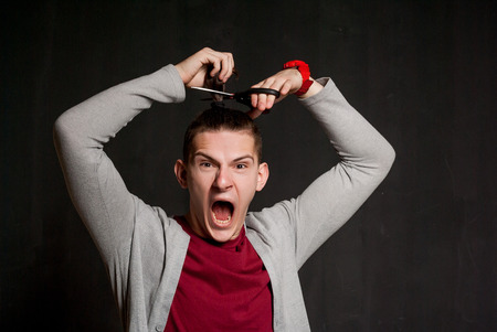 attractive emotional man in studio on background