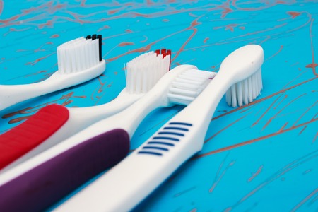 Manual toothbrush set isolated on blue background. Four colours.の写真素材
