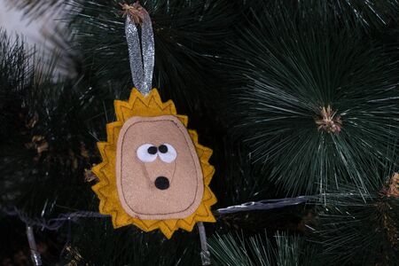 Handmade toy from felt on Christmas treeの写真素材