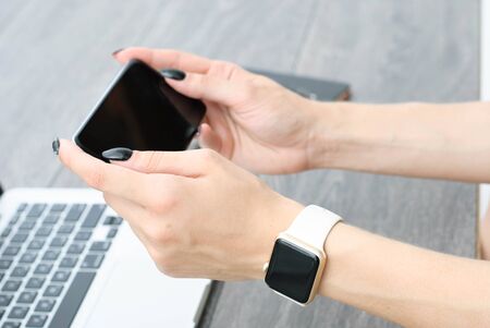 smartphone in the hands of a girl, forefinger clicks on the smartphone screen