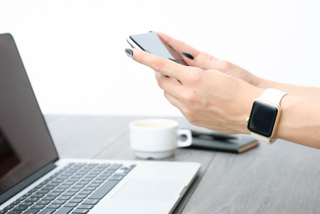 smartphone in the hands of a girl, forefinger clicks on the smartphone screenの写真素材