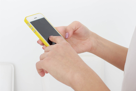 Woman holding smartphoneの写真素材