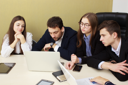 Business - team meeting in an office with laptop, boss with his employeesの写真素材