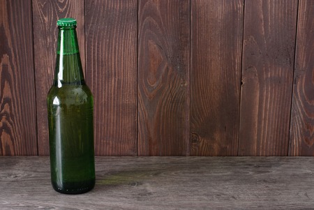 bottle of beer on a wooden backgroundの写真素材