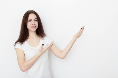 Young casual woman In pink blouse isolated over white background studio portraitの写真素材