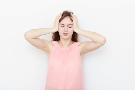Young casual woman In pink blouse isolated over white background studio portraitの写真素材