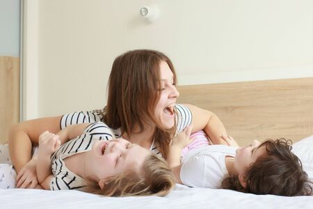 Happy loving family. Mother and her daughter child girl playing and hugging.の写真素材