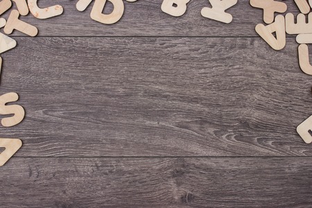 Wooden letters on wooden board background. Copy space for your textの写真素材