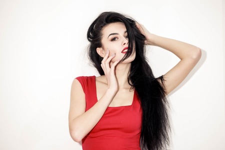 Beautiful sexy brunette girl with red lips in dressの写真素材