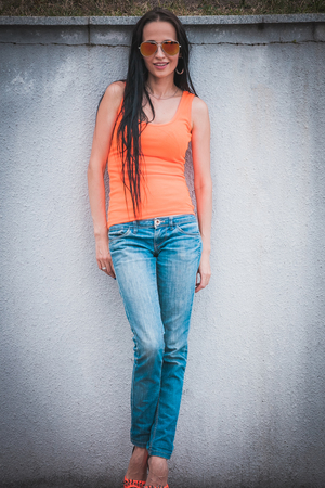 Full length portrait of a beautiful woman in blue jeansの写真素材