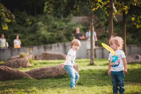 Family playing gliding toy on meadow in parkの写真素材