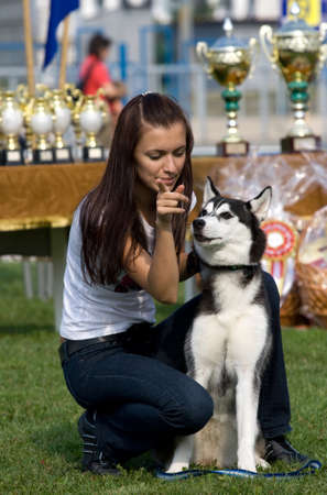 Happy owner with her siberian husky dogの写真素材