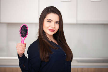 Girl holds a hairbrushの写真素材