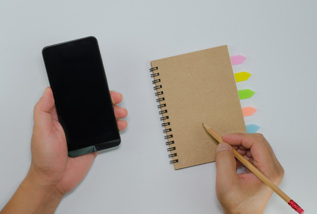 Catch smartphone recycled paper notebook front cover on white background