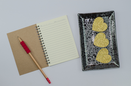 Recycled paper notebook open front cover on white backgroundの写真素材