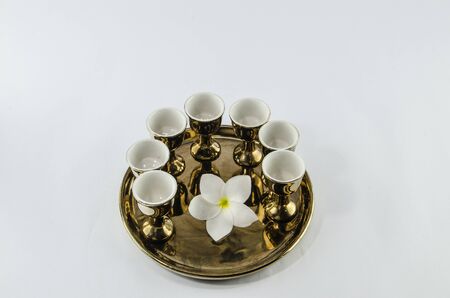 plumeria on golden plates white backgroundの写真素材