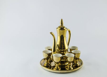 Gold jug Tea glass isolated on white background .の写真素材