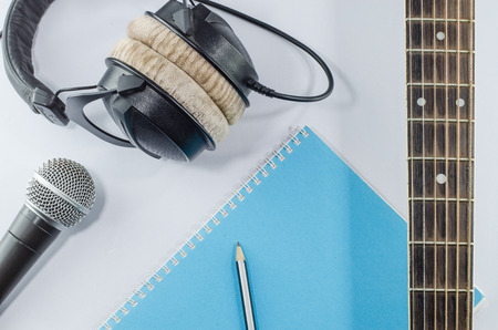 neck guitar notebook in top view with music concept whitebackground headphonesの写真素材