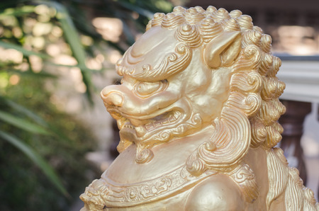 Golden lion statues in the temple town.の写真素材