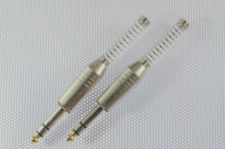 Guitar jack cables on white background