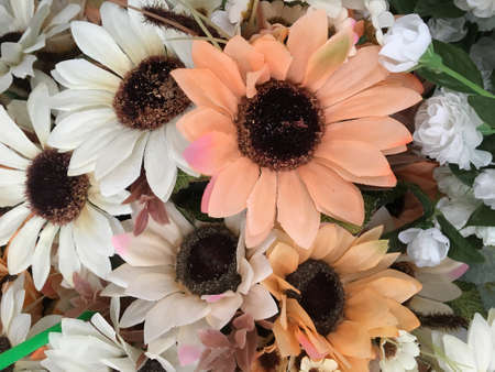 Flowers made of plastic, beautiful colors, green, red, yellow to decorate the house, office.の写真素材