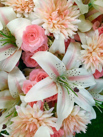 Flowers made of plastic, beautiful colors, green, red, yellow to decorate the house, office.