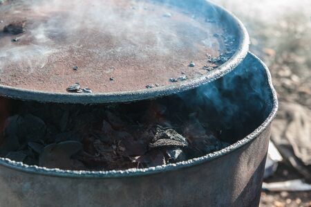 Coconut shell charcoal in steel drums.の写真素材