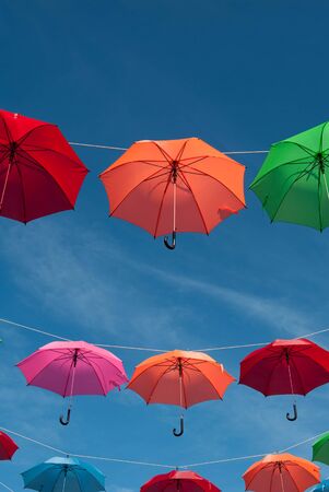 Streets are decorated with colorful umbrellas.の写真素材