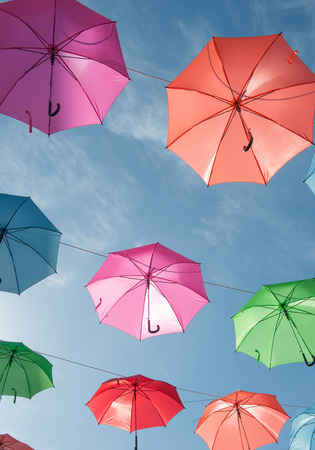 Streets are decorated with colorful umbrellas.の写真素材