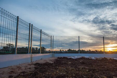 Sunrise at the lakeside fence and eliminate freedom.の写真素材