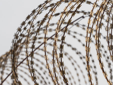Barbed wire fences around the prison prevent prisoners from escaping.の写真素材