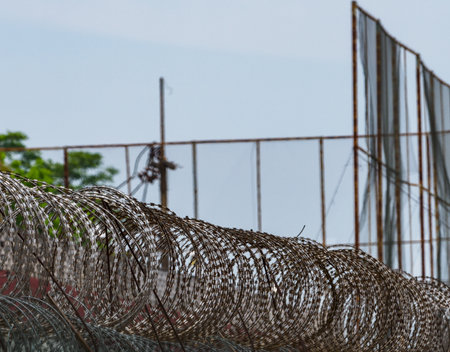 Barbed wire fences around the prison prevent prisoners from escaping.の写真素材