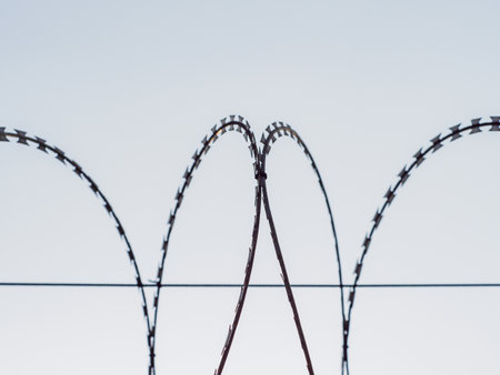 Barbed wire fences around the prison prevent prisoners from escaping.の写真素材