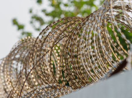 Barbed wire fences around the prison prevent prisoners from escaping.の写真素材