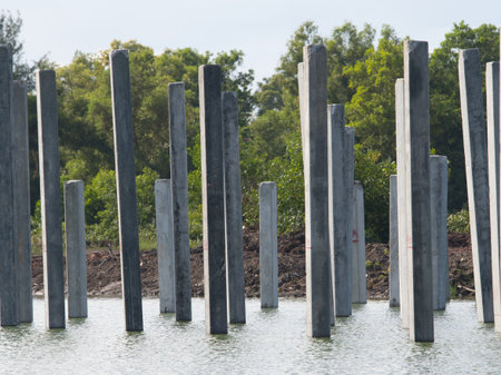 Piles of concrete poles in the water