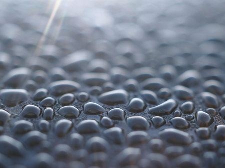 Water drops on a metal surface. Shallow depth of field.