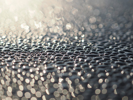 Water drops on metal surface with bokeh background, shallow depth of field