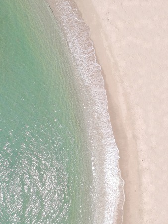 Portrait top view clear beach with wave from drone in thailandの写真素材