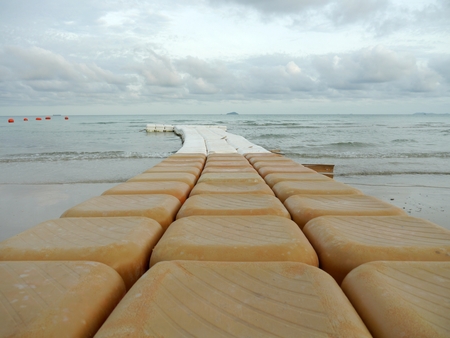 Buoys extending a long way into the sea.の写真素材
