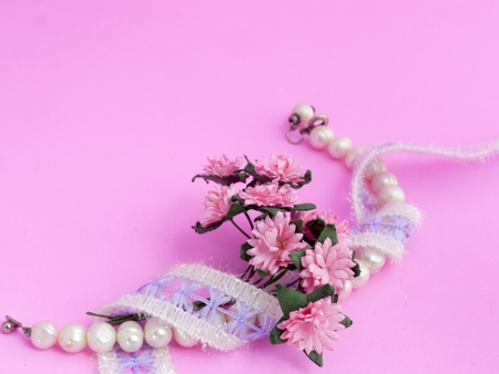 Pearl Bracelet, Lace and Daisy on Pink Backgroundの写真素材