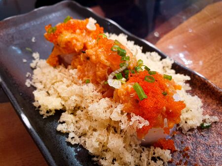 japanese food sushi roll and topping egg shrimp with Fried Tempura Flour on dishの写真素材
