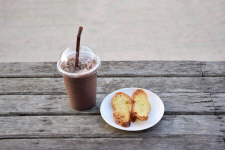 Top view of Ice Mocha coffee with Garlic Bread on wooden tableの写真素材