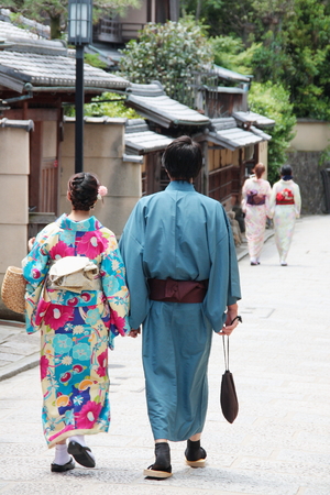 JAPAN, KYOTO - MAY 17, 2016: People dressed with traditional Japanese kimonos walking in Kyoto old town Geisha district Japan.のeditorial素材