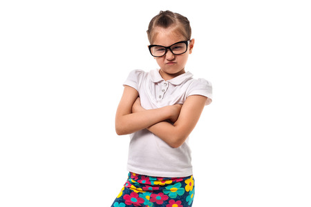 little girl in glasses standing in the pose of businessの写真素材