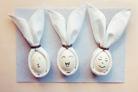 handmade Easter bunnies from eggs and cloth napkins. Rabbits with different emotions