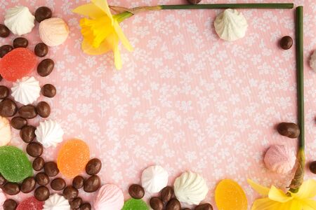 chocolates with peanuts, marshmallows and marmalade on a fabric background