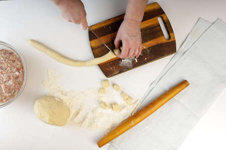 homemade dumplings in the kitchen without decorations. making dumplings with minced pork, beef and...